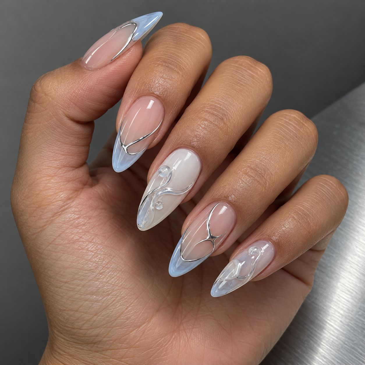 Ice-blue glass tips and silver details nail inspiration